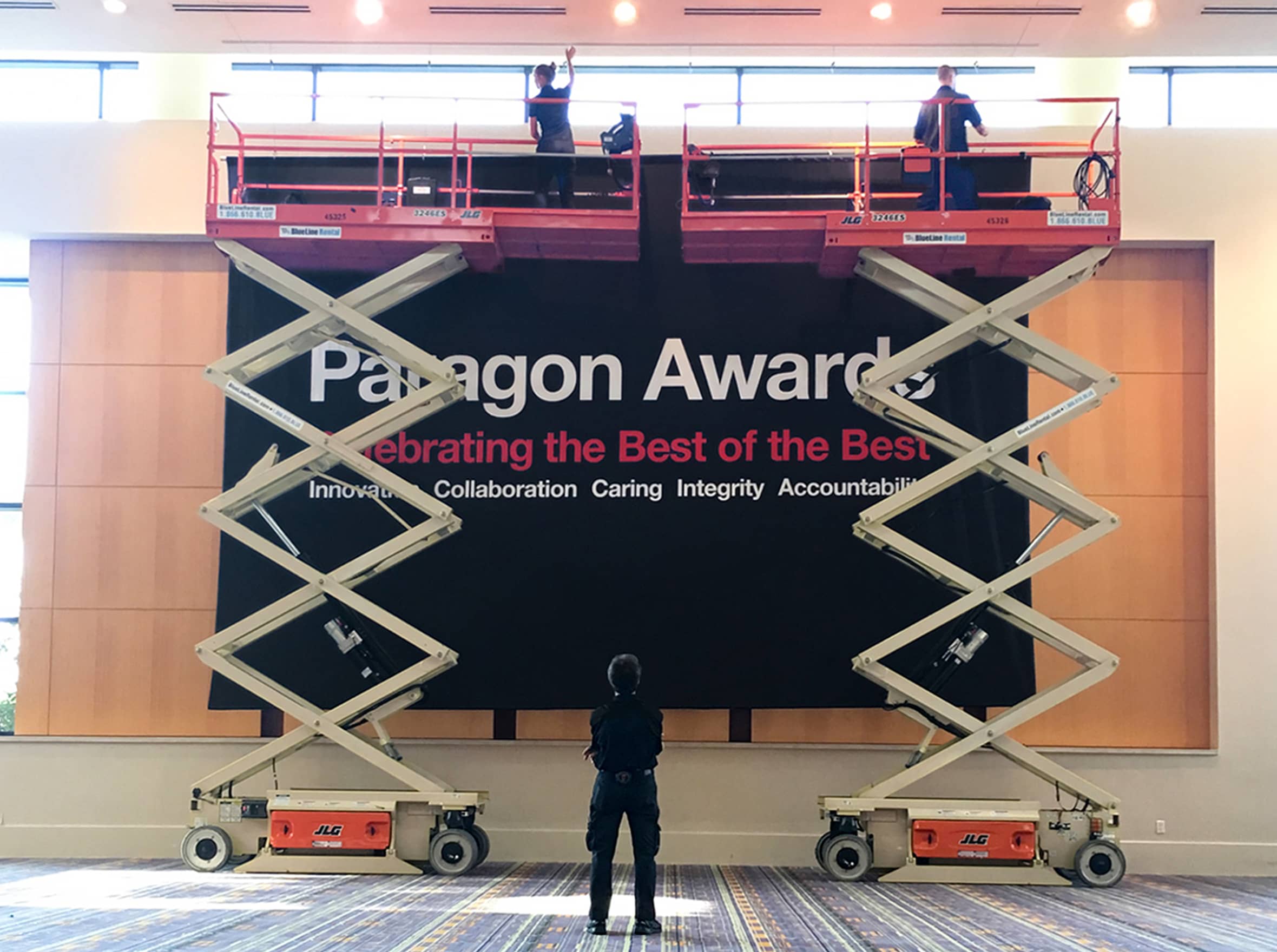 An (add)ventures crew sets up a banner at the CVS Paragon Awards