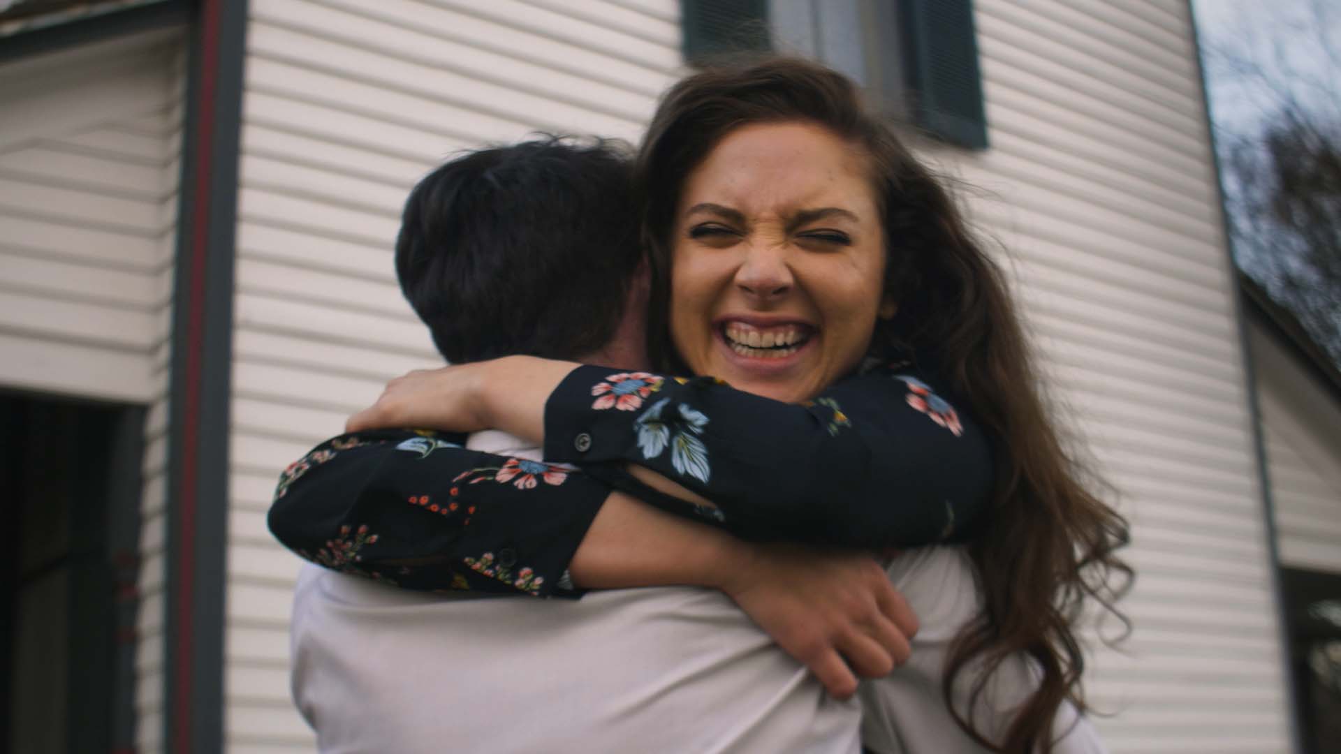 A woman embracing another human as seen in the “Delivering Hope” commercial