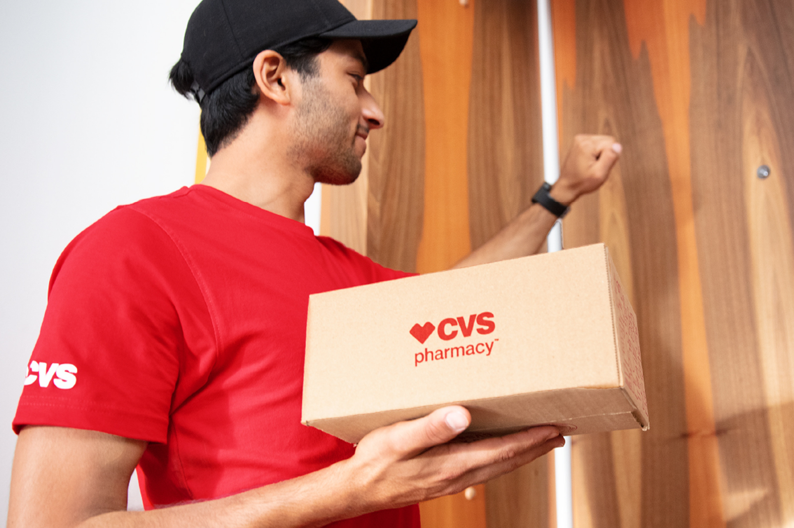 Delivery worker delivering a CVS Health package