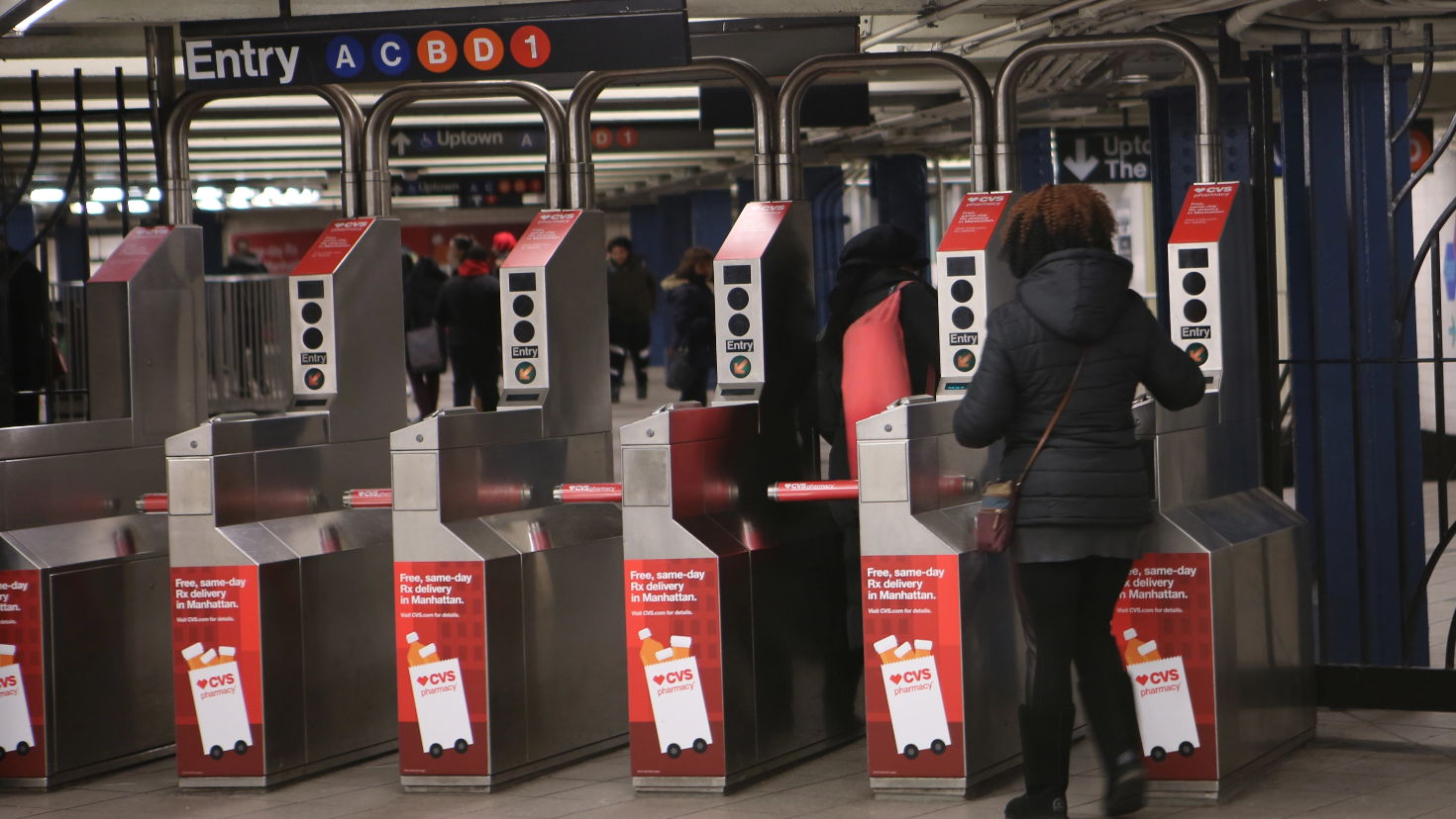 CVS Pharmacy's same-day-delivery information displayed on subway turnstiles. 